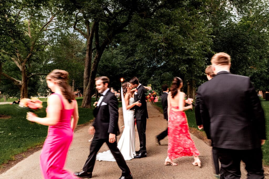 Wedding party walking around couple framing them in the center at the National Aviary