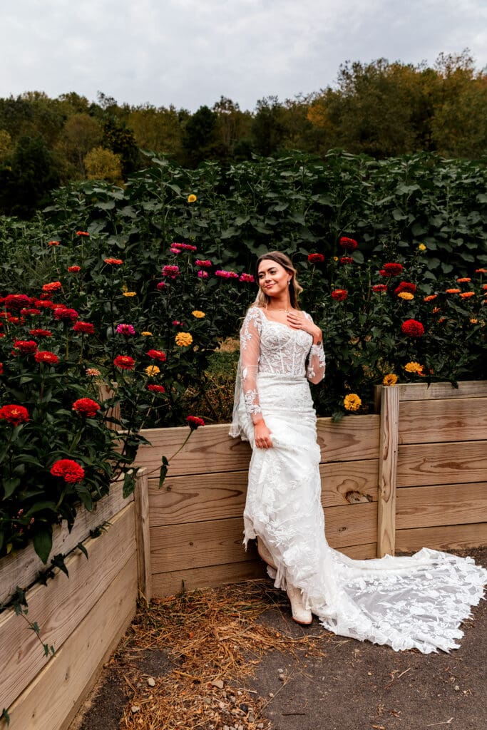 Bridal portrait session in garden with red and yellow roses at Hinckston Run Farm