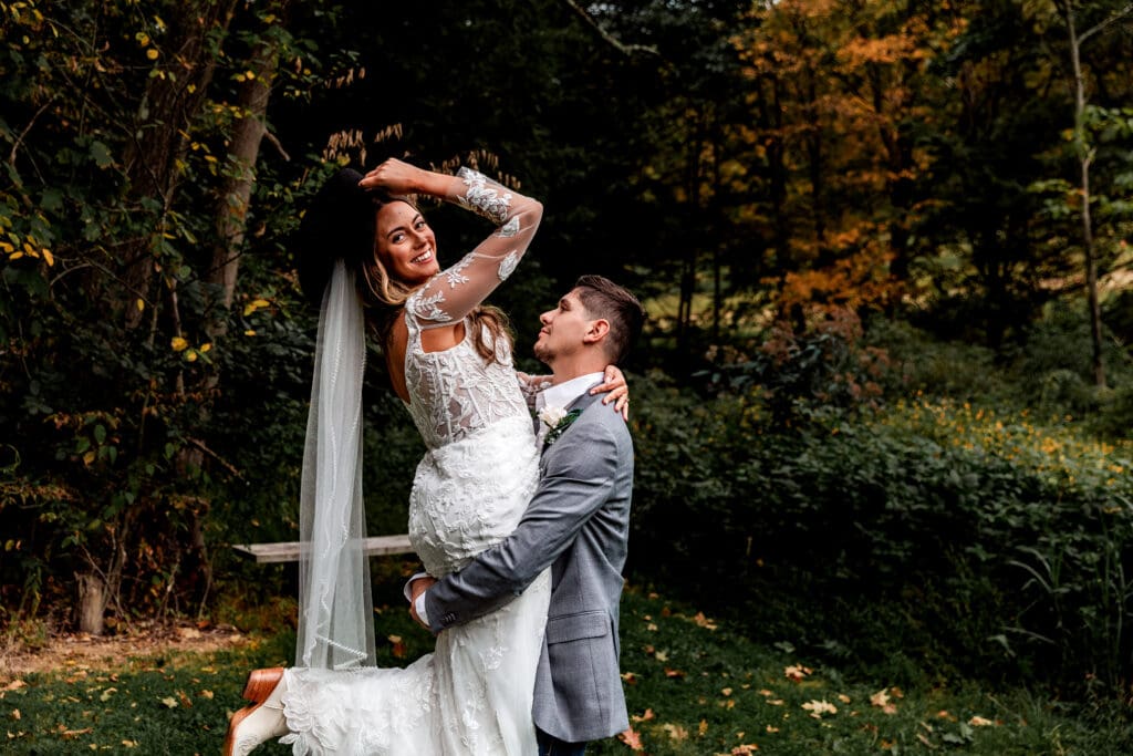 Couple sharing romantic dance in wooded outdoor setting during fall wedding at Hinckston Run Farm