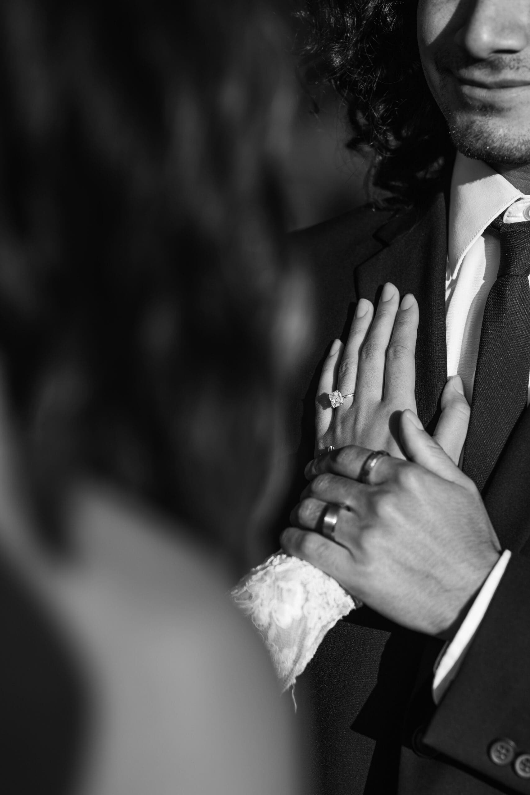 Bride gently placing her hand on the groom’s chest during a quiet and emotional moment of their outdoor elopement.