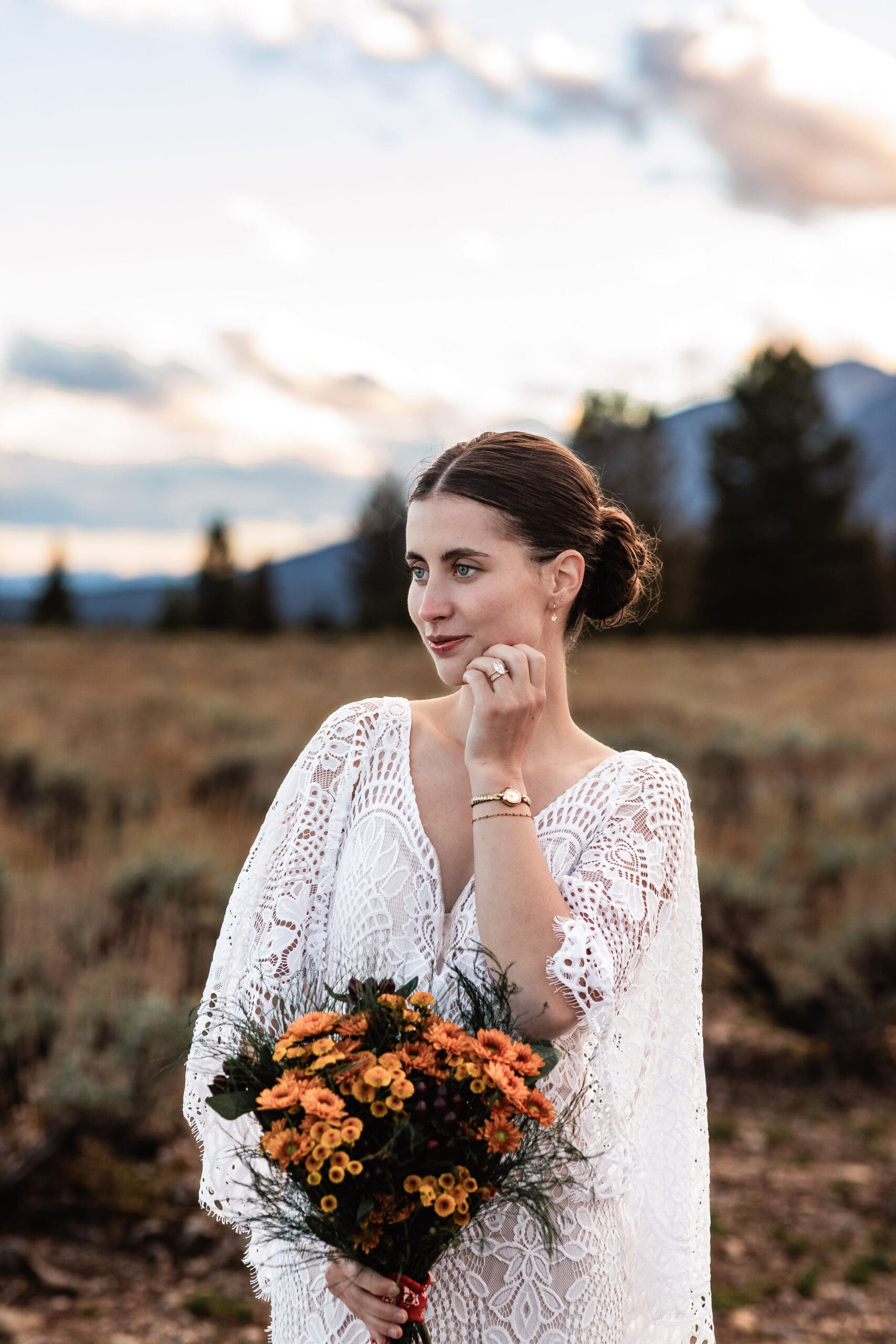 Portrait of a bride resting her engagement ring hand on her face during a quiet moment of her Grand Teton elopement.