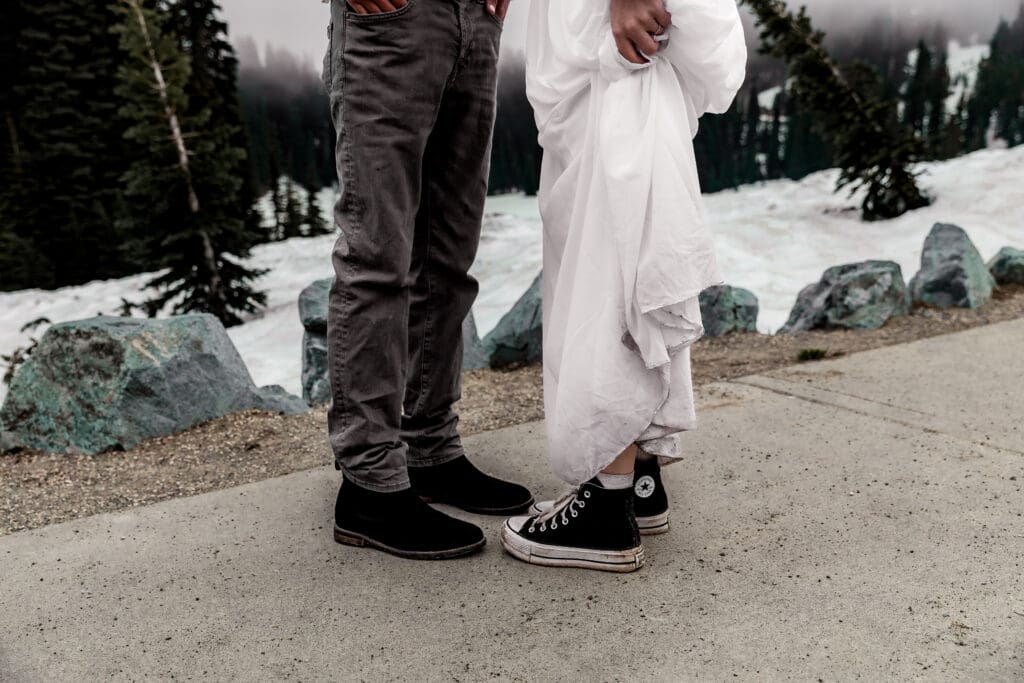 Close-up of the couple’s casual shoes including the bride’s Converse sneakers during their adventure elopement.