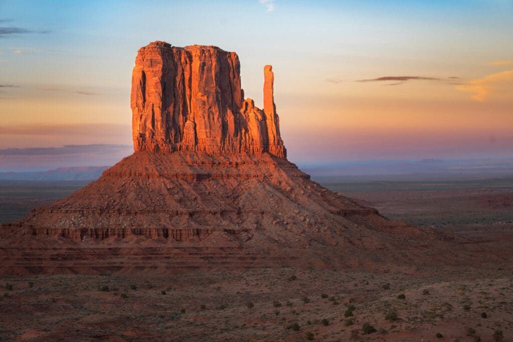 Golden sunset lighting towering desert buttes in Valley of the Gods