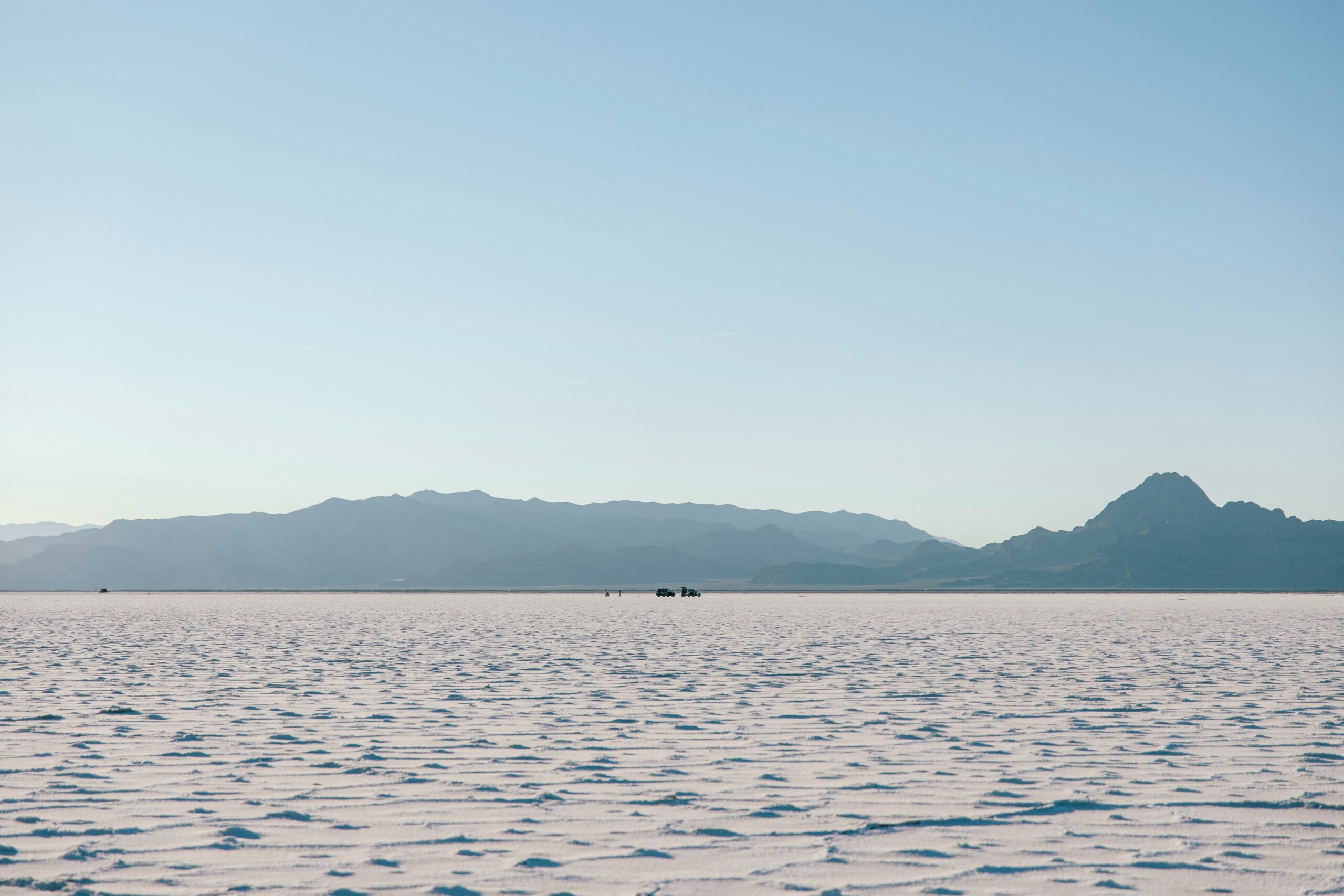 Bonneville Salt Flats Utah at sunrise with white salt ground stretching into the horizon and soft reflective surface.