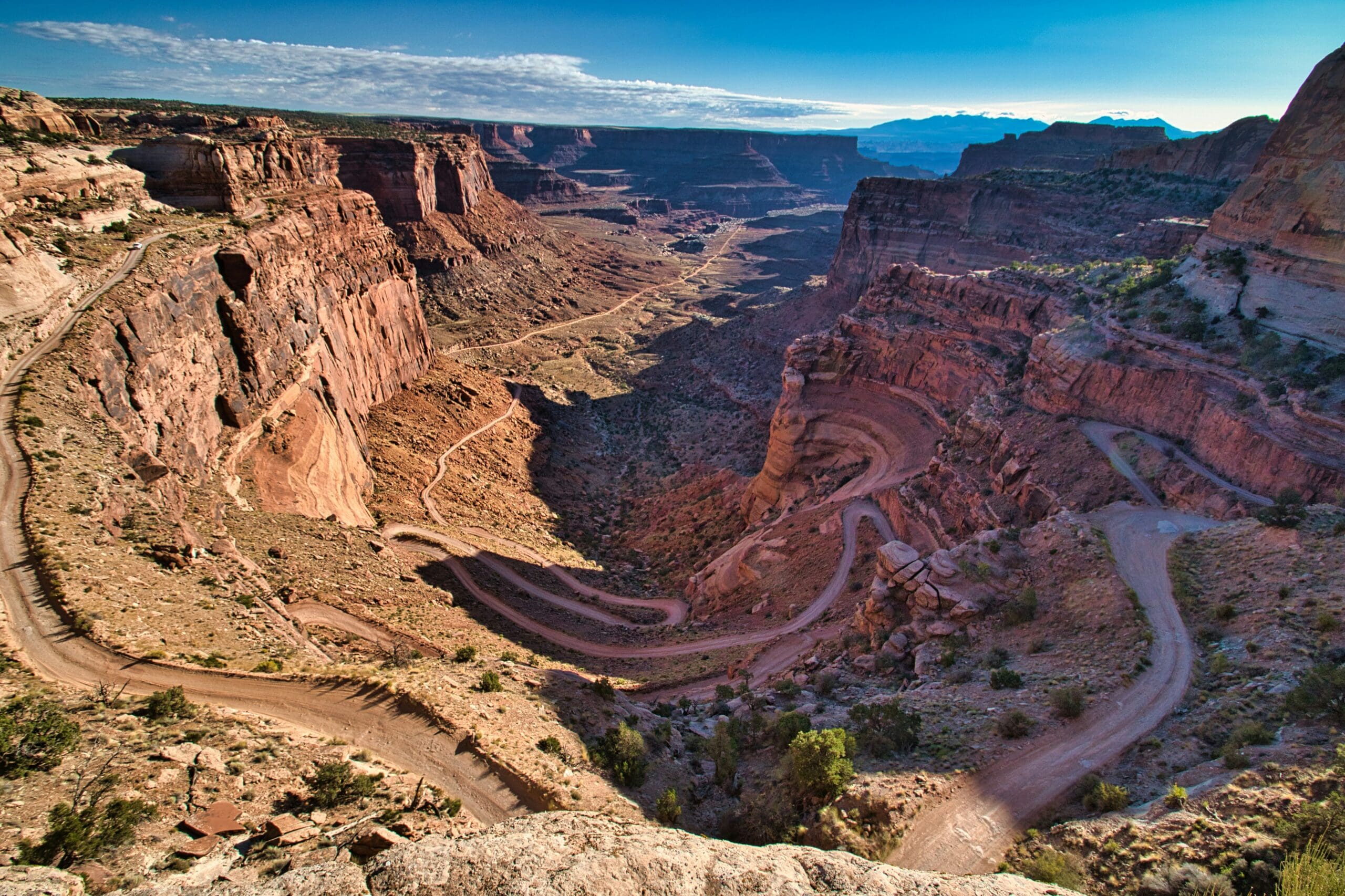 Shafer Canyon Overlook in Canyonlands National Park with sweeping desert canyon views at sunset.