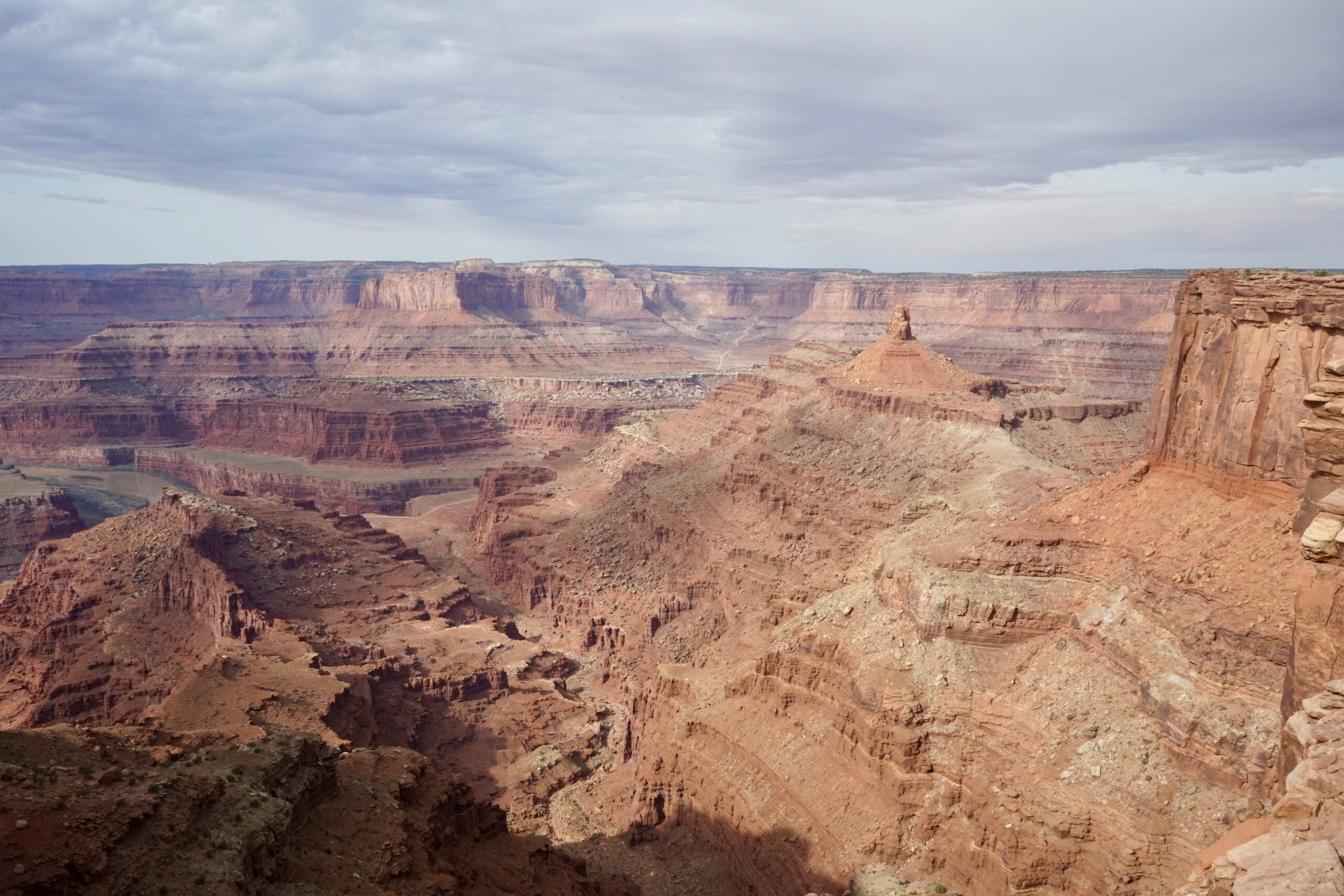 Wide canyon overlook at Dead Horse Point State Park in Moab, Utah with layered red rock cliffs and the Colorado River winding through the desert landscape